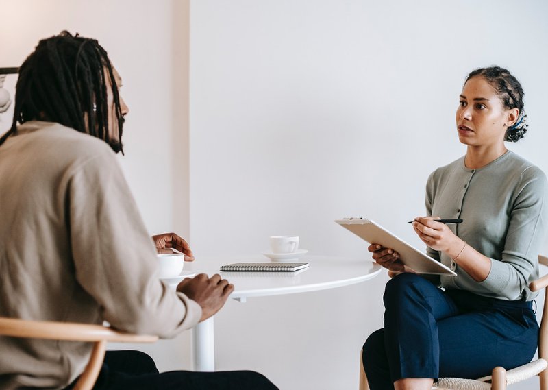 An interviewer screening a website designer applicant.