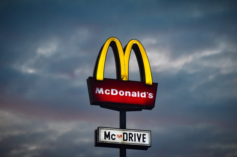 A logo of a known brand glowing in a cloudy sky.