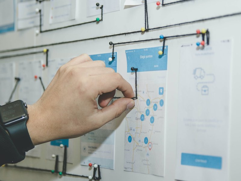 A UX designer planning how each features interact with each other by incorporating current UX design trends.